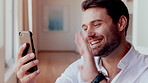 Phone, wave and man with video call in home, online communication and greeting for weekend networking. Connection, mobile and person with hello gesture for virtual conversation, smile and web chat