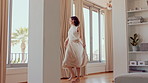 Dance, energy and walking in home with woman excited for property investment or relocation. Happy, movement and satisfaction with homeowner person in apartment for real estate celebration or success