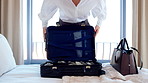 Woman, travel and packing with suitcase for flight booking, journey or business trip in home. Female person, traveler or getting ready with clothing, luggage or passport for career opportunity