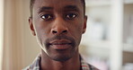 Calm, serious and face of man in house with peaceful morning, weekend break or solitude on day off. Chill, black person or quiet afternoon in living room for me time, passive emotion or relax in home