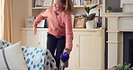 Dancing, cleaning and happy girl with rhythm, energy or vibe for groove, holiday or weekend in home. Excited, child or teenager with vacuum or movement in living room for audio or music in house