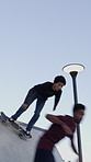 Men, ramp and stunt with skateboard for exercise, extreme sports and practice with friends. Skateboarder, training and group at skatepark for competition, hobby and balance outdoor with blue sky
