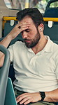 Businessman, laptop and earphones in bus with stress, headache or deadline pressure on work commute. Person, audio tech and journey in public transport with migraine, time delay or computer for email