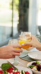 Family, hands and cheers with juice, home and social gathering with healthy food and lunch together. Brunch, celebration and people with beverage for toast, parents and meal with children in house