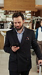 Hotel, walking and businessman with phone in lobby for check in, reservation and accommodation. Travel, hospitality and person with luggage on cellphone for booking, work trip and conference schedule
