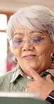 Thinking, home and senior woman on tablet for entertainment, social networking and game. Retirement, happy and elderly person on tech for digital crossword, message and website notification on app