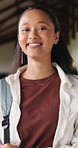 Happy, education and face of woman at college with confidence for study scholarship. Smile, knowledge and portrait of female student in hallway with pride for future or university goals on campus.