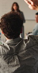 Student, answer and listening to lesson in classroom, education and teacher with project explanation. Back, learner and person with knowledge, discussion and question for exam or learning in school
