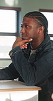 Listening, college and boy in classroom for notes, studying and learning in lesson at university. School, academy and person with notebook for education, knowledge and  lecture to prepare for exams