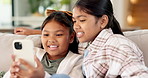 Happy, girls and siblings with phone on sofa for social media, connection or texting in home. Sisters, siblings or children with smile on mobile smartphone for online chatting or network in house