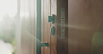 Entrance, security and sunlight in home for real estate or residential property ownership in summer. Handle, lock and wooden door of modern apartment with accommodation, flare or housing feature