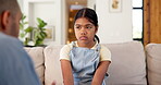 Sad, kid and father with lecture on sofa for bad behavior, discipline and agreement to warning. Lesson, strict dad and scolding unhappy child in home for teaching manners, explain rules and guidance