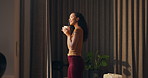 Window, coffee and woman in hotel with morning, holiday and luxury room for hospitality. Happiness, calm and person thinking by curtain with cup of tea, drink or relaxed for accommodation or vacation