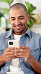 Happy man, online and texting with phone in house, communication and laughing at message on website. Internet, connection and person with mobile for funny chat, typing and networking on social media