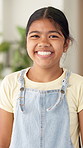 Happy, relax and face of child in home with confidence for weekend break, holiday or peace. Smile, development and portrait of girl kid with pride for growth in living room on vacation in house.