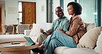 Couple, tablet and paperwork for finance in home with smile, discussion or application for insurance. People, woman and man with digital tech for budget, documents and income for savings on sofa