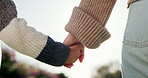 Person, outdoor and holding hands with child for bonding, support and explore in park. Family, parent and love with kid for relationship, development and trust in nature together with connection