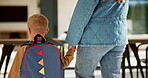 Education, mother and kid holding hands in home for kindergarten start, back to school or growth. First day, mom or child with schoolbag in morning for leaving house, learning development and walking