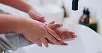 Soap, bathroom and parent with child washing hands for learning hygiene, disinfection and cleaning. Family, teaching and person with kid with water for wellness, health and germ protection in home