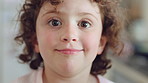 Face, child and curious girl in home with smile, thinking and wellness for childhood development. Happy, innocent young kid relax and calm in house with memory, peace and wonder for future growth.