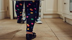 Feet, dancing and child with parent in home for rhythm, energy or bonding in kitchen together. Weekend, music and legs of girl kid with person for grooving to radio with love, care and connection.