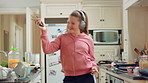 Audio, headphones and kid dance in home with energy, streaming service and album playlist. Excited girl, music and moving at kitchen with phone for sound, freedom and listening to radio with rhythm