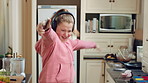 Headphones, excited and kid dance in kitchen with energy, streaming service and music playlist. Girl, audio and moving at home with phone for sound, freedom and listening to radio song on weekend