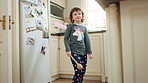 Costume, dance and child with smile in kitchen, creative expression and playing for imagination growth. Childhood, spoon and happy girl with fantasy dress up for development, home and moving to music