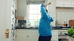 Kitchen, dance and teen with spoon, spin and performance for cooking success and moving with energy. Dancer, active and person with down syndrome, rhythm and celebration for culinary skills in house