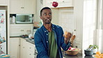 Dancing, juggle and black man in kitchen with energy for performance, humor and expression in home. Happy, movement and male person with fruit for hobby, entertainment and weekend fun in apartment