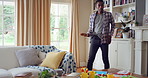 Dancing, rhythm and black man in living room with energy for celebration, performance and expression. Happy, movement and male person with hip hop for hobby, entertainment and weekend fun in home