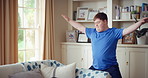 Active, man and goofy in living room, dance and move with energy and celebration on university break. Fun, home and person with down syndrome, education and student with rhythm on weekend or hobby