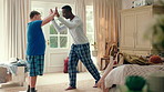 Happy, high five and friends in home with handshake for bonding, connection and support. Morning, bedroom and man with person with down syndrome for relationship, greeting and practice on weekend
