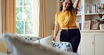 Woman, dancing and singing in living room with smile, wellness or listen to music on weekend break. Happy, female person and streaming playlist in home with fun energy, good mood or movement to song.