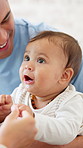 Happy, playing and baby with parents in home for bonding, connection and early childhood development. Smile, cute and child with mother and father for family together with growth on weekend in house.