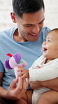 Father, baby or child with toy for development, learning and growth in family home. Toddler, infant kid and man or single parent with love, care and security for mobility and playing in bedroom