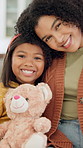 Happy, face and mother with child on sofa for comfort, bonding and trust in home. Teddy bear, love and portrait with woman and girl or daughter for relationship, affection and connection on weekend
