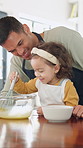 Teaching, egg and kid baking with dad in kitchen for recipe preparation in family home. Mixing, cooking education or girl learning for child development with father, man and dessert or sweat treat