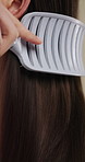 Hands, cosmetics and woman with brush for haircare, healthy growth and split ends removal. Self care, routine and person with hairbrush on closeup for beauty, scalp stimulation and style maintenance