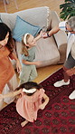 Parents, children and dancing in living room with family connection, bonding together and support. Above, happy people and music in home with mother, father and girl kids holding hands for rhythm.