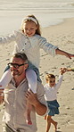 Family, father and girl on shoulder at beach with smile, fun and bonding on vacation in summer. People, children and parents with connection, happy and holding hands with walk on seaside holiday
