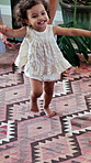 First steps, milestone and walking with in home with parents, toddler and development or growth. Balance, learning or support with mom, dad and excited child in house for motor skills or movement