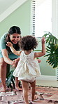 Steps, milestone and walking with in home with mother, toddler and development or growth. Balance, learning and support with mom, dad and excited child in living room for motor skills or movement