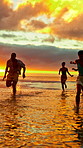 Sunset, running and friends in sea for holiday, tropical destination and summer break for adventure. Island vacation, travel and group of people with weekend trip for bonding, seaside getaway or fun 