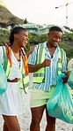 Clean up, NGO and people on beach for community, service or sustainability program outdoor. Happy, trash bags and group of volunteers with social responsibility for waste management by ocean.
