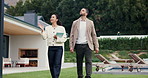 Woman, realtor and tour with customer for property investment, sale or inspection in backyard. Female person, real estate agent or walking with client on lawn for home viewing or house accommodation