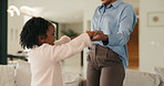 Mother, child and holding hands in living room with dance, trust and bonding together for weekend break. Mom, young daughter smile and play in home with rhythm, music or support for family connection
