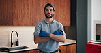 Smile, face or plumber in house with arms crossed, pride or ambition in repair services. Happy, handyman or male person in kitchen with confidence, opportunity or experience in sanitation systems.