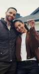 Keys, face and couple with smile for new home, property and investment success. Security, happiness and man or woman with hug and achievement outdoor for mortgage, real estate or house purchase