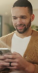 Texting, smile or man in living room with phone, online conversation or notification on dating app. Happy, typing or male person in house with tech, romance match or message in partner search